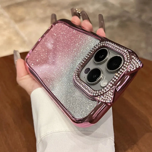 Phone case with glittery design held by a hand on a wooden surface